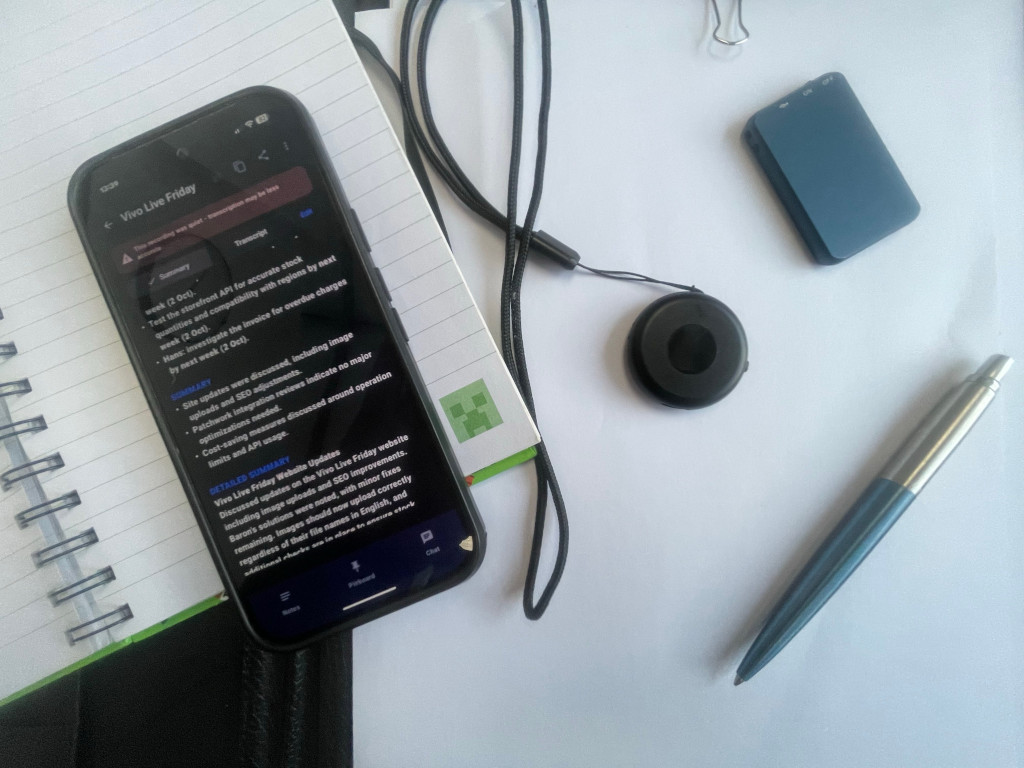 A generic USB voice recorder held in a hand